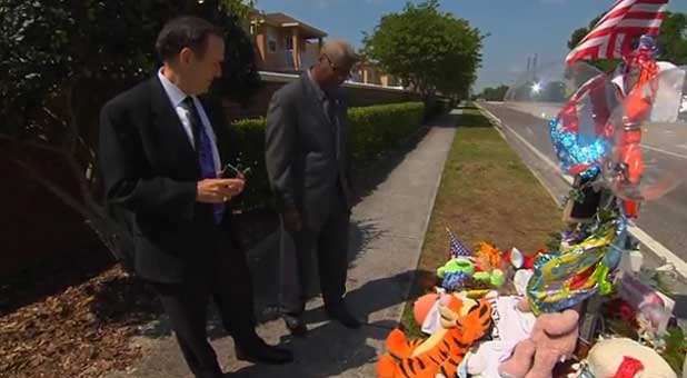 Me (l) and Dr. Raleigh Washington look over a memorial to Trayvon Martin (Charisma Media)