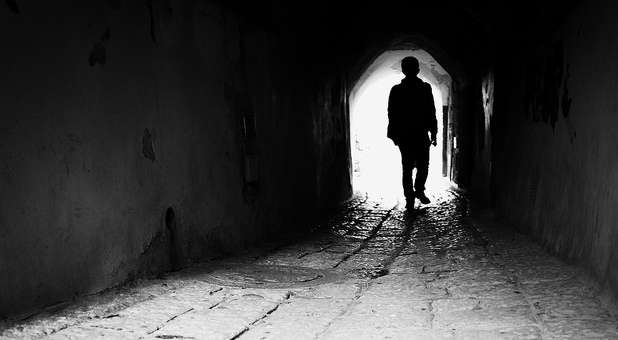 Person walking through tunnel