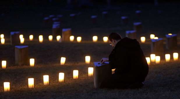 A man pays his respects during a commemoration ceremony for the 70th anniversary of the liberation of Auschwitz death camp.