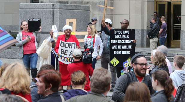 Supporters and opponents of same-sex marriage hold signs on the steps of Jefferson County Courthouse in Birmingham, Alabama.