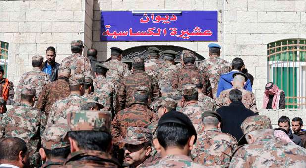 Jordanian soldiers are seen at the headquarters of the family clan of pilot Muath al-Kasaesbeh.