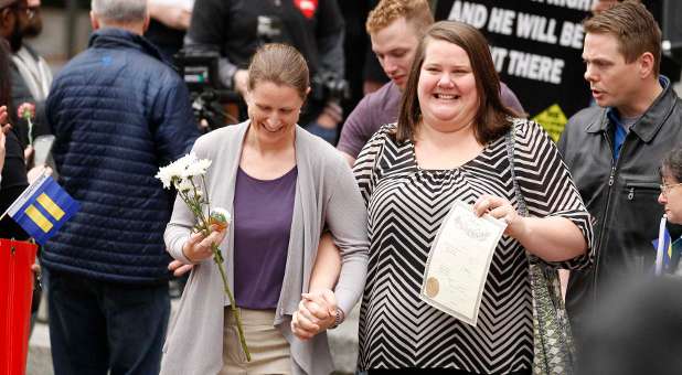 A couple displaying their marriage license