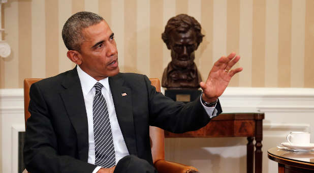 U.S. President Barack Obama talks to reporters in the Oval Office.