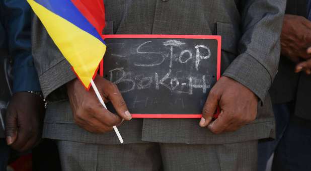 A man holds a sign that reads