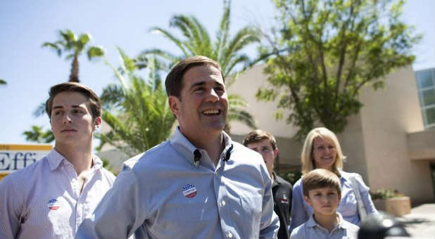 Arizona Gov. Doug Ducey signed a bill blocking abortion coverage through Obamacare.