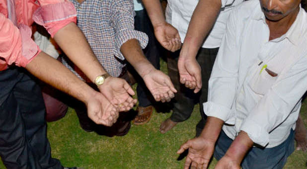 Christians display their bruised and swollen wrists after they were tortured.