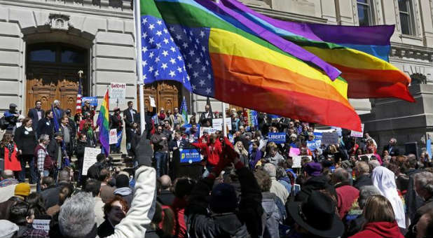 Demonstrators gather to protest Indiana's Religious Freedom Restoration Act.