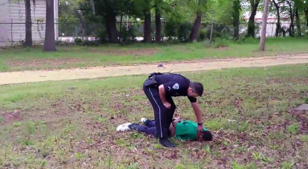 North Charleston police officer Michael Slager is seen standing over 50-year-old Walter Scott after allegedly shooting him in the back as he ran away, in this still image from video in North Charleston, South Carolina taken April 4, 2015