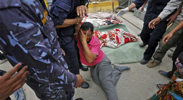 A man mourns his wife, who was killed in the earthquake.