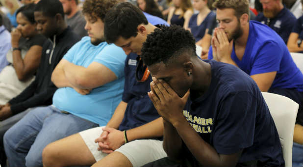 Men and women gather to remember the victims of the shooting at the Emanuel African Methodist Episcopal Church.