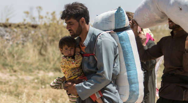 A family flees their home after an Islamic State attack.