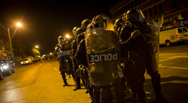 Baltimore police respond to riots earlier this year. Three were killed when a gunman opened fire near the University of Maryland, Baltimore.