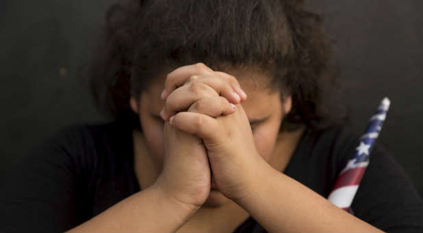 A woman prays at a memorial for the Chattanooga shooting victims.