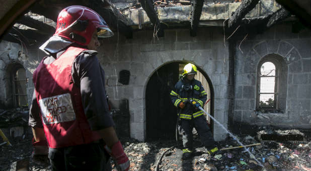 Suspects were formally charged in the arson of the church built on the site where Jesus multiplied loaves and fishes.