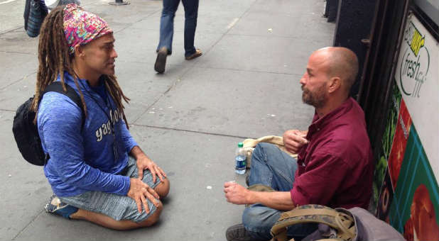 Todd White, left, ministers to someone on the street.