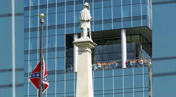 A Confederate flag is removed outside a South Carolina building. The University of Texas is removing their statue of Jefferson Davis from outdoors.