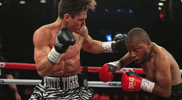 Dustin Fleischer (l) in the ring, with the Star of David on his trunks