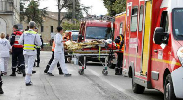 Rescue workers carry a injured person on a stretcher during rescue operations near the site where a coach carrying members of an elderly people's club collided with a truck outside Puisseguin near Bordeaux, France.