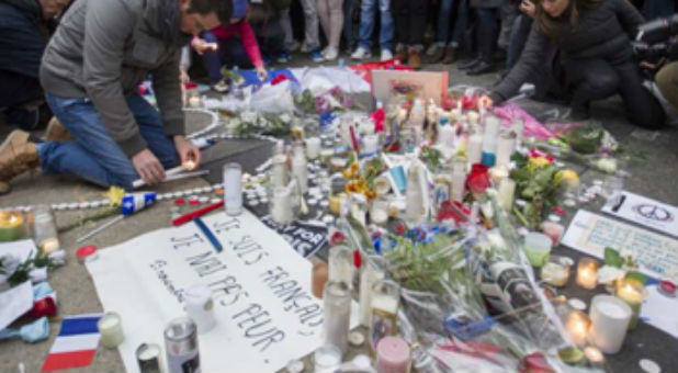 People gather to remember the victims of the Paris attacks.