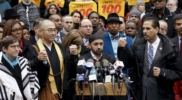 Interfaith leaders gather at a rally to condemn Donald Trump's proposed ban on Muslims.