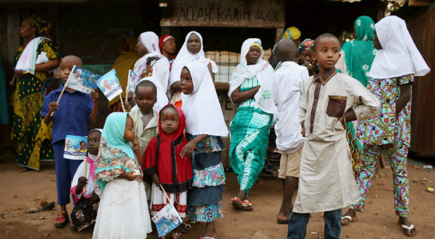 Muslim children await the arrival of Pope Francis.