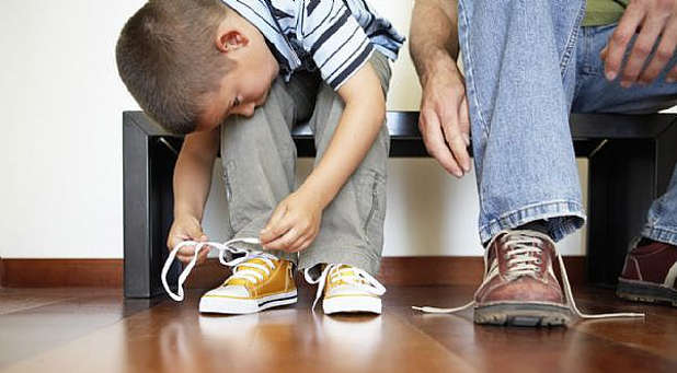 Child tying shoe