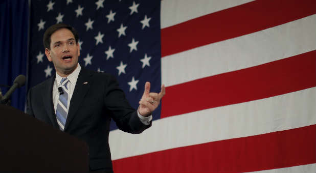 Marco Rubio speaking in front of U.S. flag