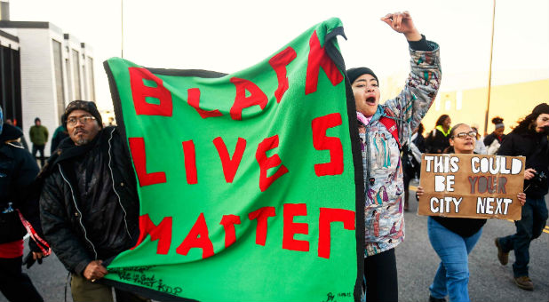 Members of the group Black Lives Matter march to city hall during a protest in Minneapolis, Minnesota.