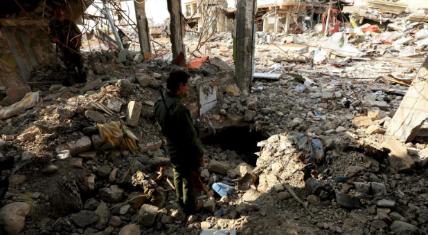 A member of the peshmerga forces inspects a tunnel used by Islamic State militants in the town of Sinjar, Iraq.