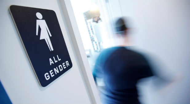 A bathroom sign welcomes both genders at the Cacao Cinnamon coffee shop in Durham North Carolina.