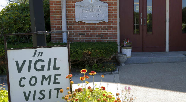 A sign marks the vigil at St. Frances Xavier Cabrini Roman Catholic church