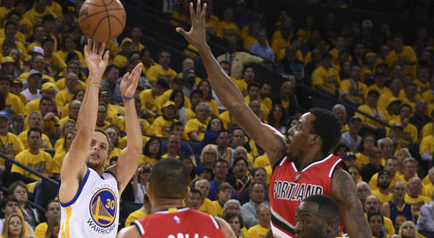 Golden State Warriors guard Stephen Curry (30) shoots the basketball against Portland Trail Blazers center Ed Davis (17)