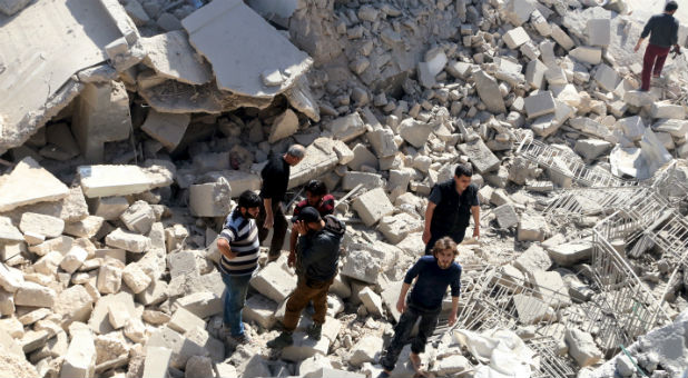 Residents look for survivors amidst the rubble after an airstrike on the rebel-held Old Aleppo