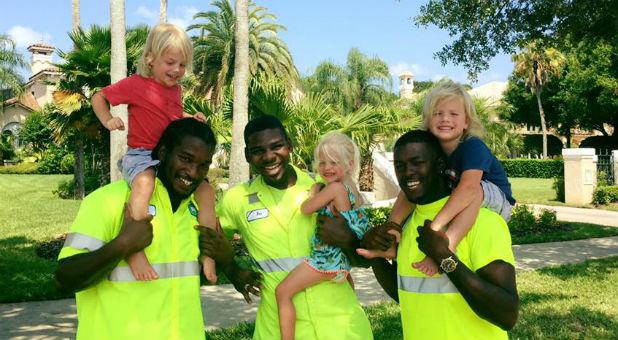 Martha Sugalski's triplets with their favorite people ever, the garbage men!