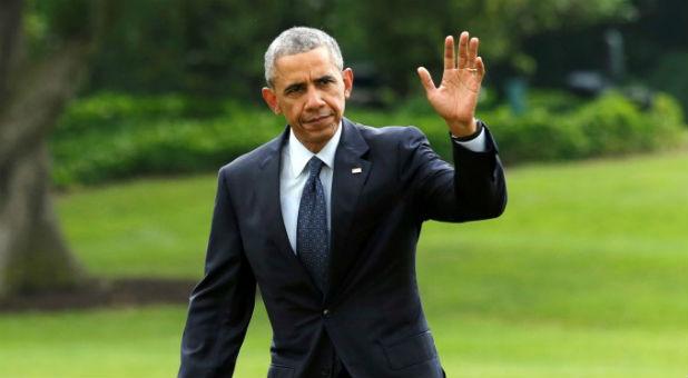 U.S. President Barack Obama waves as he walks on the South Lawn of the White House upon his return to Washington, U.S., from Orlando.