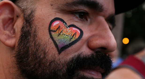 People take part in a vigil for the Pulse night club victims following last week's shooting in Orlando.