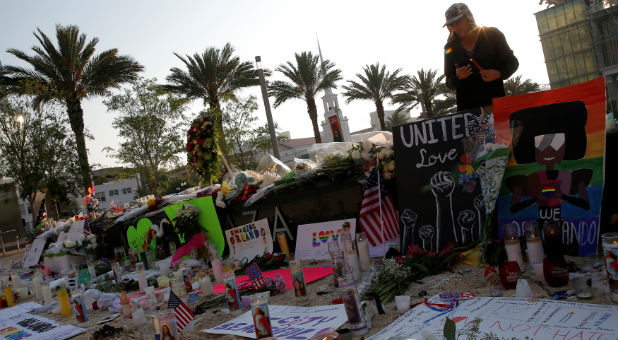 Tony Backe lights a candle at a vigil for the victims of the shooting at the Pulse gay nightclub in Orlando, Florida.