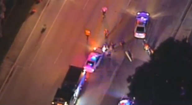 Police cars gather outside the crime scene.