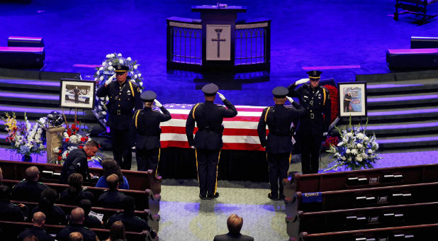 Police officers pay their respects ahead of the funeral for Officer Lorne Ahrens