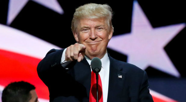 Republican presidential nominee Donald Trump points at the gathered media during his walk through at the Republican National Convention in Cleveland