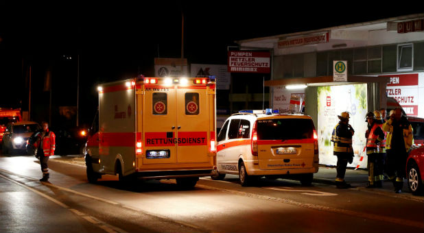 German emergency services workers work in the area where a man with an ax attacked passengers on a train near Wuerzburg.