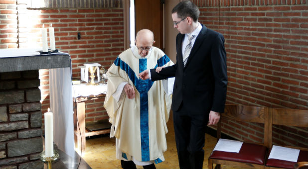 Father Clemens arrives to attend a mass at St. Benoit church in Nalinnes