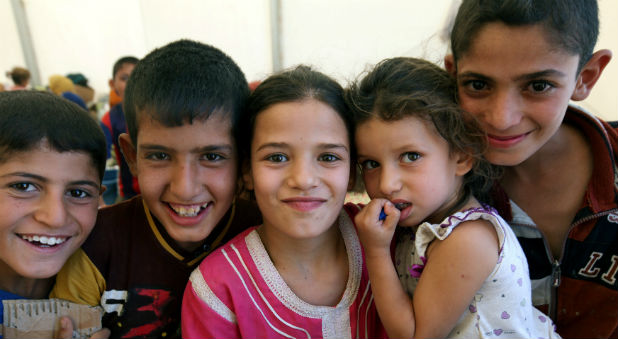 Displaced Iraqi children, who fled from Qayyara because of Islamic State violence, poses for a photograph at a refugee camp in the Makhmour area near Mosul