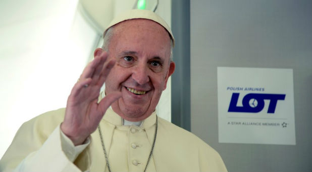 Pope Francis aboard a plane.