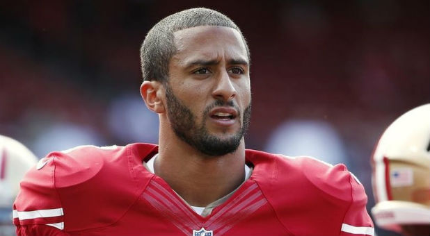 San Francisco 49ers' Kaepernick stands on the field before their NFL pre-season football game against Denver Broncos in San Francisco