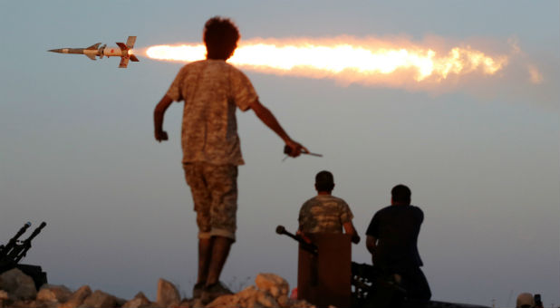 Fighters of Libyan forces allied with the U.N.-backed government fire a rocket at Islamic State fighters in Sirte, Libya