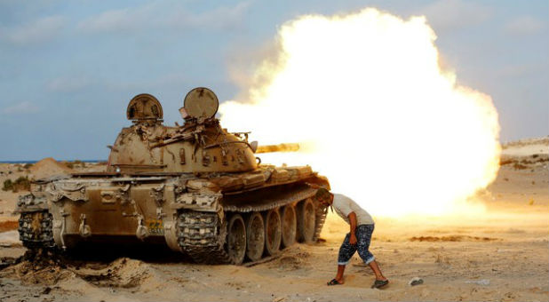 A fighter of Libyan forces allied with the U.N.-backed government fires a shell with Soviet made T-55 tank at Islamic State fighters in Sirte