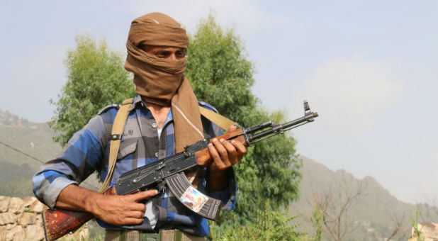 A non-government fighter stands guard in Iran.