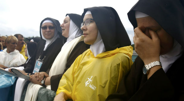 Nuns wait for Pope Francis farewell ceremony at Balice airport near Krakow