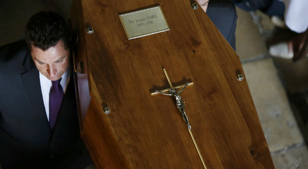 Pallbearers carry the coffin of slain French parish priest Father Jacques Hamel after a funeral ceremony at the Cathedral in Rouen